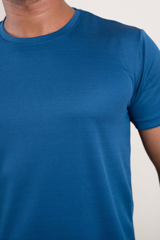 Close-up of the stitching and hem of the active blue crew neck t-shirt, highlighting its durable construction